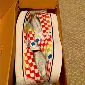 A pair of rainbow checkered vans